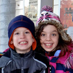 two smiling kids in winter caps