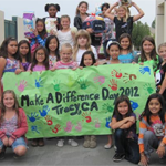 kids holding a make a difference poster