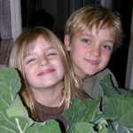 two children holding cauliflower